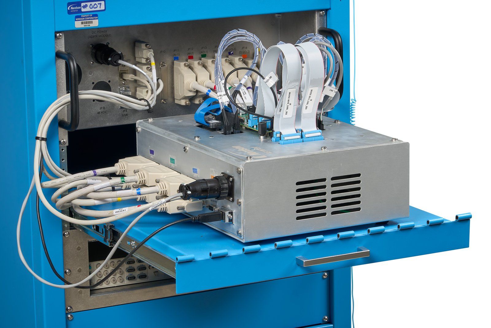 Electronics module wired into a blue test cabinet on a pull-out tray