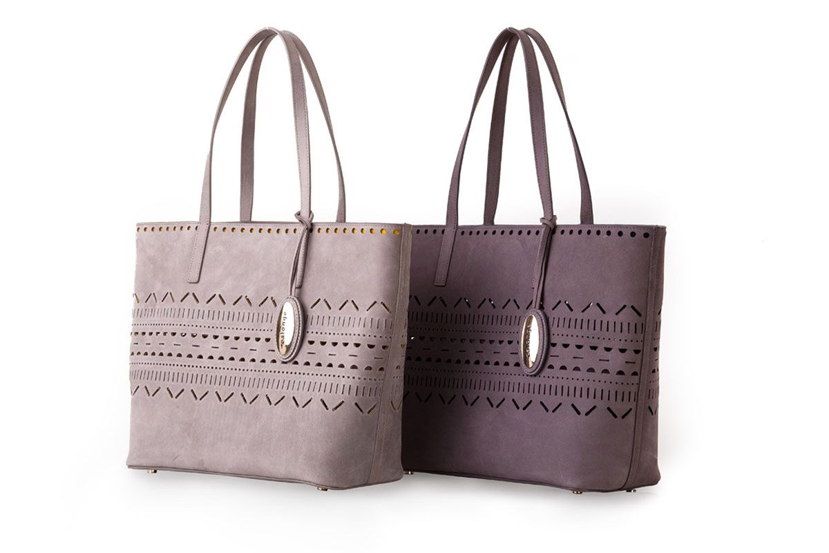 Two perforated suede tote bags in grey and plum on a white background